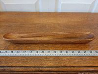 Top view showing full length of teak tray beside ruler