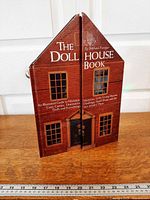 Front view of closed dollhouse-shaped hardcover book