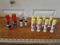 Front view showing all 12 glue sticks arranged by brand