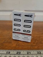 Front view of two sealed Goda perfume boxes