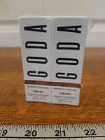 Front view of both sealed Goda For Her perfume boxes