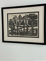 Full view of framed woodcut print on wall