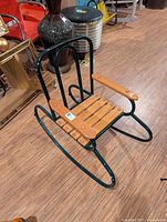 Full view of metal frame children’s rocker with wood slats