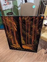 Front view of black velvet painting showing cedar forest scene
