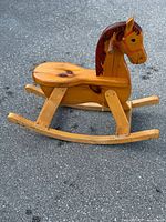 Left side view of pine rocking horse showing mane, seat and rocker rails