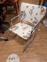 Front angled view showing full chair, vinyl print and metal frame