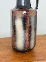 Side view showing earthen drip glaze and handle