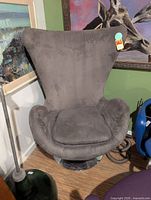 Front view of grey swivel egg chair showing overall design, cushion and base