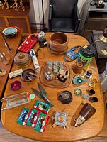 Overall view of assorted teak, metal, plastic and ceramic items laid on table