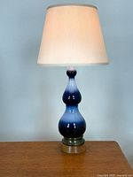 Front view of cobalt blue triple gourd glass lamp with shade