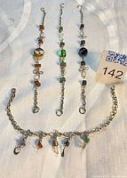 Four bracelets laid out showing overall designs and length