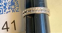 Ring on mandrel showing stamped 925 decorative band design