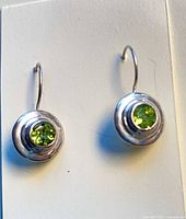 front view of both earrings showing peridot stones and silver bezels