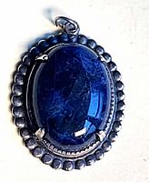 Front view of oval sodalite pendant showing stone color and silver beaded border