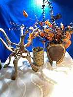 All three items together: wooden stand, woven basket, clay pot with foliage