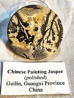 Front view of round dendritic jasper cabochon