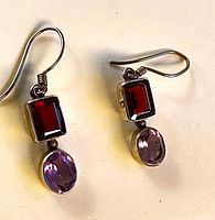 Front view of both earrings showing garnet and amethyst stones with hooks