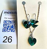 Necklace and earrings set displayed on card showing overall design and scale