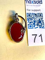 Front view of sterling silver wire wrapped carnelian pendant with lot tag