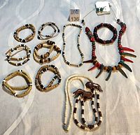 All jewelry items laid out: seven chokers, spike necklace, dolphin necklace, earrings