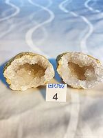 Both geode halves showing crystal interiors with lot tag