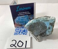 Larimar slice on stand with information card and QR code visible, label 201