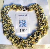 Full view of serpentine chip collar necklace laid flat with MaxSold card