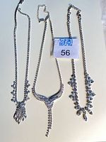 All three rhinestone chokers laid out showing designs and length adjusters