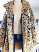 Front view of faux fur coat on mannequin showing overall style and length