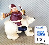 Left side view of figurine showing elf, polar bear and size tag