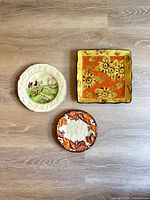 Three plates laid out: fox-hunt, sunflower, autumn leaves