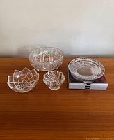All four crystal and glass pieces grouped on tabletop