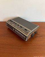 Angled view showing side knobs and woodgrain finish