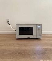 Front view of Panasonic microwave powered on