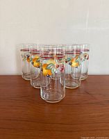 Front view of six fruit motif glasses