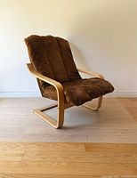 Three-quarter front view of chair showing frame and cushion