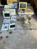 Full lot showing Apple II computer, monitor, manuals, cables