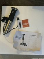 Anova Precision Cooker with manuals on table