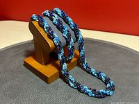 Necklace and bracelet displayed on stand showing twisted multi-strand seed bead construction and colour tones