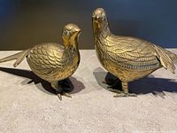 Pair of brass pheasant sculptures showing feather detail, overall form and patina