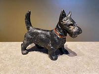 profile view of black cast iron Scottie dog with red collar