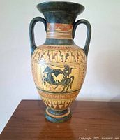 Full view front of amphora vase showing twin handles and figural rooster medallion