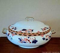 Full view of tureen with lid showing decoration and handles