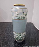 full view of vase front showing floral design and grid pattern