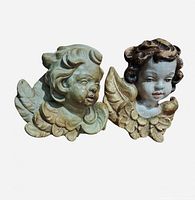 Both cherub head plaques front view