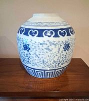 Front view of blue and white porcelain jar showing lotus motif and geometric patterns