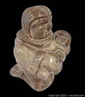 Front angled view of the stone Inuit mother and child sculpture
