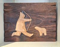 Full view of wood relief showing hunter and animal figures