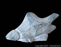 Left side view of soapstone fish sculpture showing full profile and dorsal fin