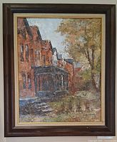 Framed impressionist oil painting of brick row houses